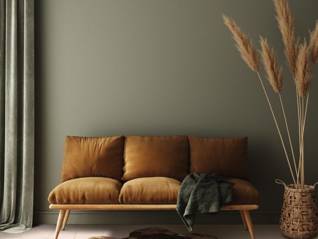 Modern dark green home interior with brown couch and pampas in wicker basket, 3d render